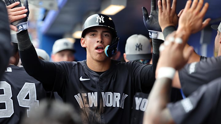 Feb 22, 2025; Dunedin, Florida, USA;  New York Yankees shortstop George Lombard Jr. (96)  is congratulated after he scored a run during the sixth inning against the Toronto Blue Jays at TD Ballpark. Mandatory Credit: Kim Klement Neitzel-Imagn Images