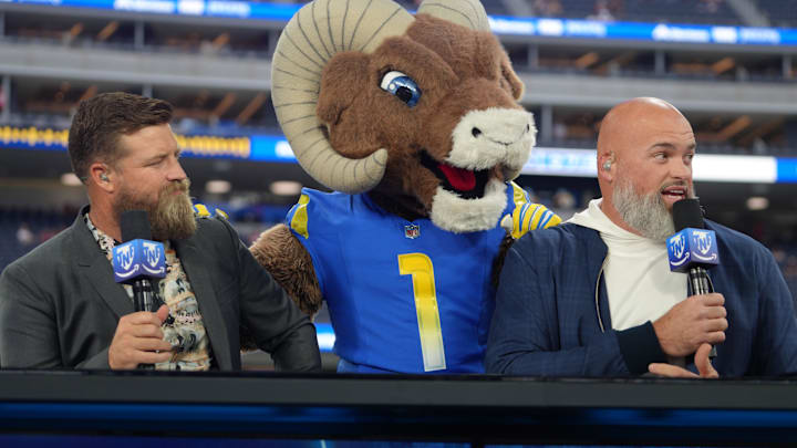 Oct 2, 2025; Inglewood, California, USA; Los Angeles Rams mascot Rampage (center) visits Ryan Fitzpatrick (left) and Andrew Whitworth on the Prime Thursday Night Football set at SoFi Stadium. Mandatory Credit: Kirby Lee-Imagn Images