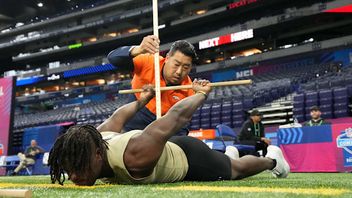 Mar 2, 2024; Indianapolis, IN, USA; Denver Broncos Western National area scout Sae Woon Jo measures Southern Mississippi running back Frank Gore (RB11) during the 2024 NFL Scouting Combine at Lucas Oil Stadium. Mandatory Credit: Kirby Lee-Imagn Images