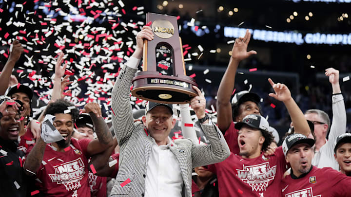 Mar 30, 2024; Los Angeles, CA, USA;  Alabama Crimson Tide head coach Nate Oats celebrates with the trophy after defeating the Clemson Tigers in the finals of the West Regional of the 2024 NCAA Tournament at Crypto.com Arena. 