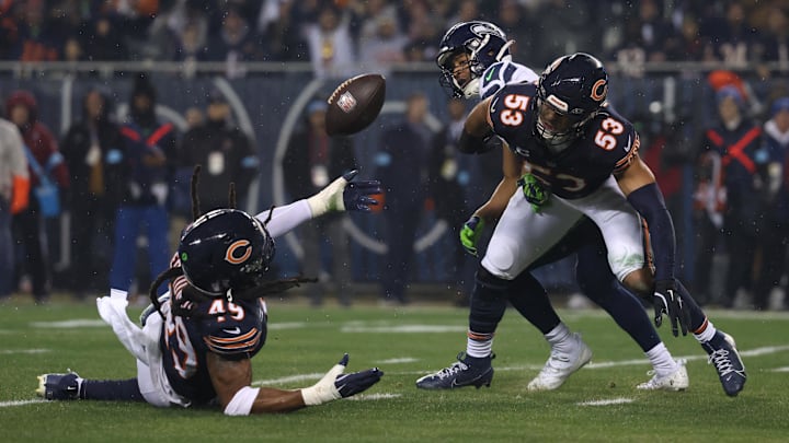Tremaine Edmunds (49) and linebacker T.J. Edwards try to secure the ball on a tipped pass against Seattle last season.