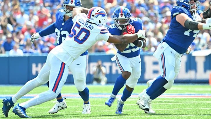 Aug 9, 2025; Orchard Park, New York, USA; Buffalo Bills defensive end Greg Rousseau (50) tackles New York Giants running back Tyrone Tracy Jr. (29) in the first quarter at Highmark Stadium.