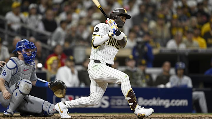 Oct 9, 2024; San Diego, California, USA; San Diego Padres outfielder Jurickson Profar (10) singles in the eighth inning against the Los Angeles Dodgers during game four of the NLDS for the 2024 MLB Playoffs at Petco Park.  Mandatory Credit: Denis Poroy-Imagn Images