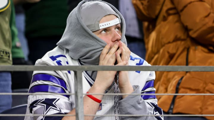 ARLINGTON, TX - JANUARY 14: Dallas Cowboys fans react to a Green Bay Packers touchdown during the NFC Wild Card game between the Dallas Cowboys and the Green Bay Packers on January 14, 2024 at AT&T Stadium in Arlington, Texas.