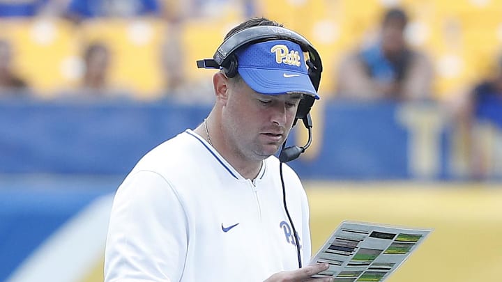Aug 31, 2024; Pittsburgh, Pennsylvania, USA;  Pittsburgh Panthers offensive coordinator Kade Bell looks at his play chart against the Kent State Golden Flashes during the fourth quarter at Acrisure Stadium. Mandatory Credit: Charles LeClaire-Imagn Images