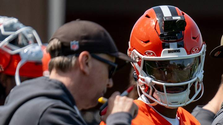 Browns quarterback Shedeur Sanders watches as head coach Todd Monken speaks on the radio during a 7-on-7 training session at minicamp, April 21, 2026, in Berea.