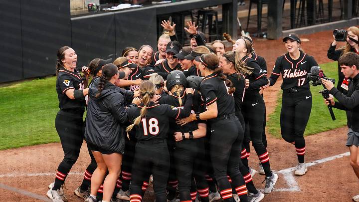 The Hokies gather at the plate in celebration.