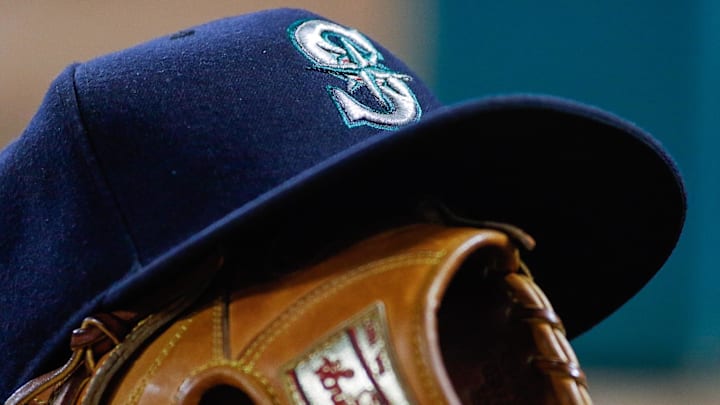 A Seattle Mariners hat and glove is pictured in the dugout during a game against the Texas Rangers on June 4, 2016, at Globe Life Field.