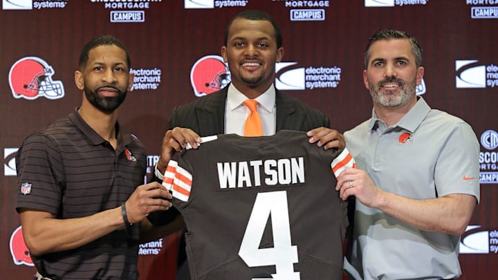 Cleveland Browns quarterback Deshaun Watson poses for a portrait with general manager Andrew Berry and coach Kevin Stefanski during Watson's introductory news conference March 26, 2022, in Berea, Ohio.