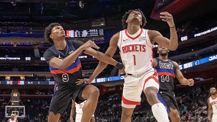 Jan 12, 2024; Detroit, Michigan, USA; Detroit Pistons forward Ausar Thompson (9) battles for for the ball with his twin brother Houston Rockets forward Amen Thompson (1) during the first half at Little Caesars Arena. Mandatory Credit: David Reginek-Imagn Images
