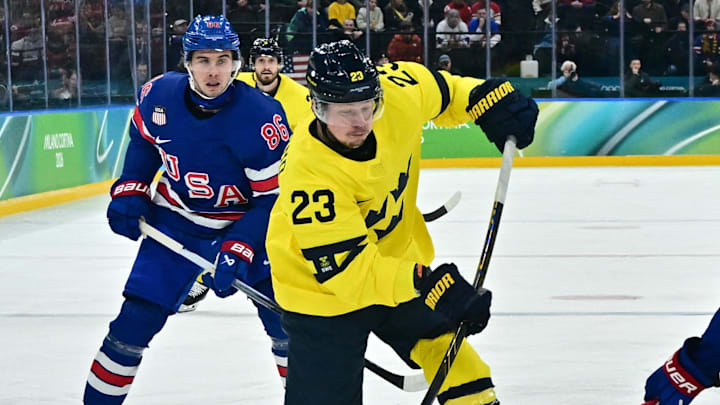 [US, Mexico & Canada customers only] Feb 18, 2026; Milan, Italy; Lucas Raymond of Sweden in action with Jaccob Slavin of United States  in a men's ice hockey quarterfinal during the Milano Cortina 2026 Olympic Winter Games at Milano Santagiulia Ice Hockey Arena. Mandatory Credit: Marton Monus/Reuters via Imagn Images