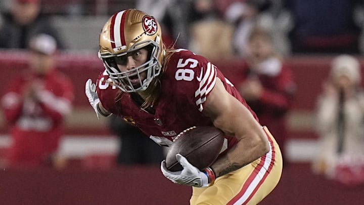 San Francisco 49ers tight end George Kittle (85) picks up 32 yard on a reception after a missed tackle by Green Bay Packers safety Jonathan Owens during the third quarter of their NFC divisional playoff game Saturday, January 20, 2024 at Levi    Stadium in Santa Clara, California. The San Francisco 49ers beat the Green Bay Packers 24-21.