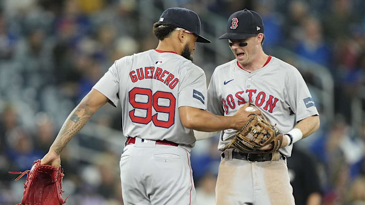 Sep 23, 2024; Toronto, Ontario, CAN; Boston Red Sox third baseman Nick Sogard (75) congratulates pitcher Luis Guerrero (99) after catching a pop up from Toronto Blue Jays center fielder Jonatan Clase (not pictured) during the eighth inning at Rogers Centre. Mandatory Credit: John E. Sokolowski-Imagn Images