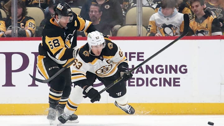 Mar 1, 2025; Pittsburgh, Pennsylvania, USA; Pittsburgh Penguins defenseman Kris Letang (58) checks Boston Bruins left wing Brad Marchand (63) during the first period at PPG Paints Arena. Mandatory Credit: Charles LeClaire-Imagn Images Mar 1, 2025; Pittsburgh, Pennsylvania, USA; Pittsburgh Penguins defenseman Kris Letang (58) checks Boston Bruins left wing Brad Marchand (63) during the first period at PPG Paints Arena. Mandatory Credit: Charles LeClaire-Imagn Images