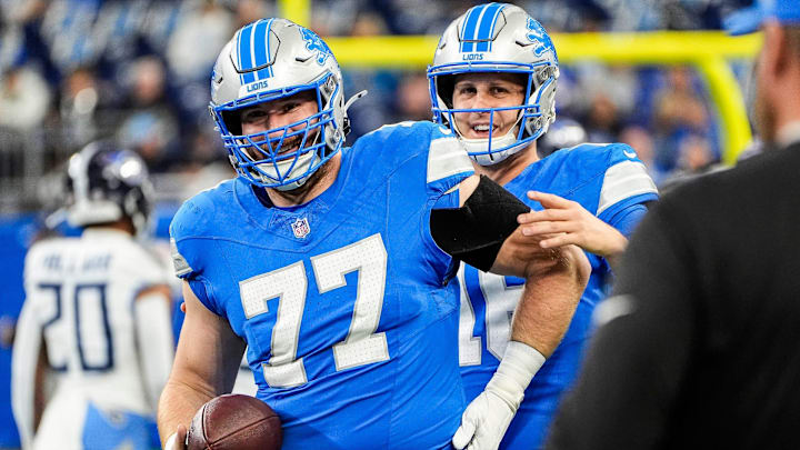 Detroit Lions quarterback Jared Goff (16) talks to center Frank Ragnow (77) during warm up before the Tennessee Titans game at Ford Field in Detroit on Sunday, Oct. 27, 2024.