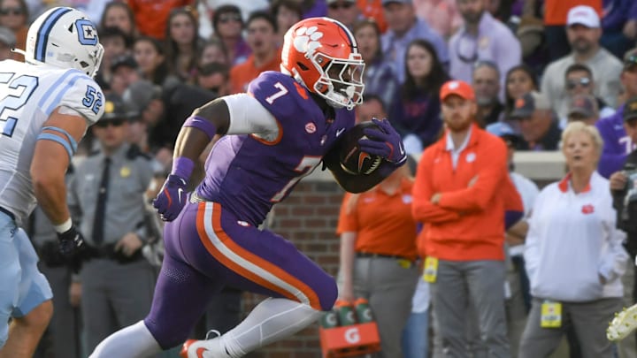 Nov 23, 2024; Clemson, South Carolina, USA; Clemson Tigers running back Phil Mafah (7) runs by The Citadel Bulldogs linebacker Camden Gray (52) during the first half at Memorial Stadium. Mandatory Credit: Ken Ruinard-Imagn Images