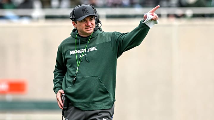 Michigan State's head coach Jonathan Smith communicates with staff on Saturday, April 20, 2024, at Spartan Stadium in East Lansing.