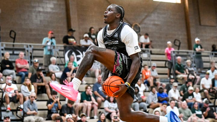Team Motorcars and Michigan State's Coen Carr dunks against Team Fargo during the Moneyball Pro-Am on Tuesday, June 24, 2025, at Holt High School. Team Motorcars and Michigan State's Coen Carr dunks against Team Fargo during the Moneyball Pro-Am on Tuesday, June 24, 2025, at Holt High School.