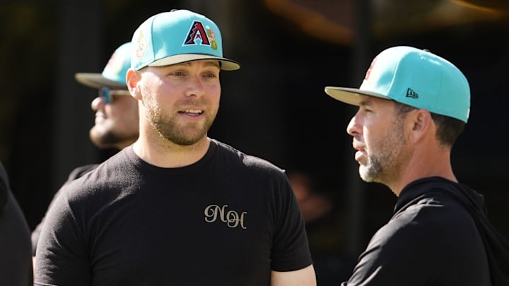 Arizona Diamondbacks pitcher Corbin Burnes (left) talks to pitching coach Brian Kaplan during spring training workouts on Feb. 10, 2026 at Salt River Fields in Scottsdale.