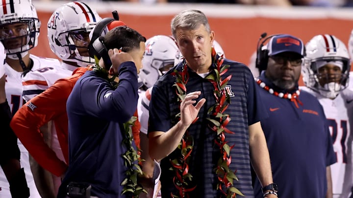 Sep 28, 2024; Salt Lake City, Utah, USA; Arizona Wildcats head coach Brent Brennan (center) during the third quarter against the Utah Utes at Rice-Eccles Stadium. Mandatory Credit: Rob Gray-Imagn Images
