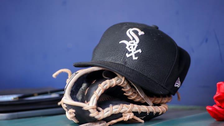 Jul 15, 2023; Atlanta, Georgia, USA; A detailed view of a Chicago White Sox hat and glove in the dugout against the Atlanta Braves in the first inning at Truist Park. Mandatory Credit: Brett Davis-Imagn Images