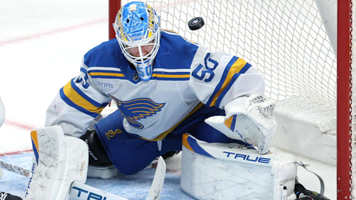 Mar 15, 2026; Winnipeg, Manitoba, CAN; A puck flies over St. Louis Blues goaltender Jordan Binnington (50) during a game against the Winnipeg Jets in the second period at Canada Life Centre. Mandatory Credit: James Carey Lauder-Imagn Images