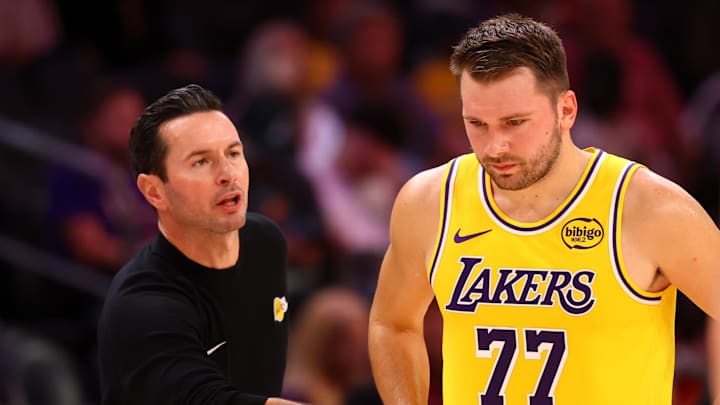 Oct 14, 2025; Phoenix, Arizona, USA; Los Angeles Lakers guard Luka Doncic (77) with head coach JJ Redick against the Phoenix Suns during an NBA preseason game at Mortgage Matchup Center. Mandatory Credit: Mark J. Rebilas-Imagn Images

