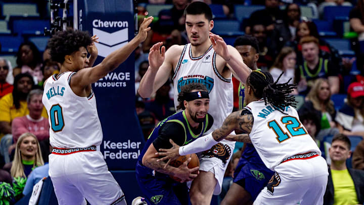 Mar 9, 2025; New Orleans, Louisiana, USA;  New Orleans Pelicans guard Jose Alvarado (15) fights for position against Memphis Grizzlies guard Ja Morant (12) and forward Jaylen Wells (0) and center Zach Edey (14) during the second half at Smoothie King Center. Mandatory Credit: Stephen Lew-Imagn Images