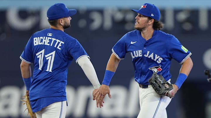 Jul 3, 2025; Toronto, Ontario, CAN; Toronto Blue Jays right fielder Addison Barger (47) and pinch hitter Bo Bichette (11) celebrate a win over the New York Yankees at Rogers Centre. 