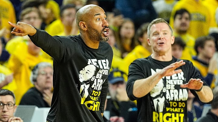 Michigan assistant coach Justin Joyner and head coach Dusty May signal players during a play against Northwestern in the overtime at Crisler Center in Ann Arbor on Sunday, Jan. 19, 2025.