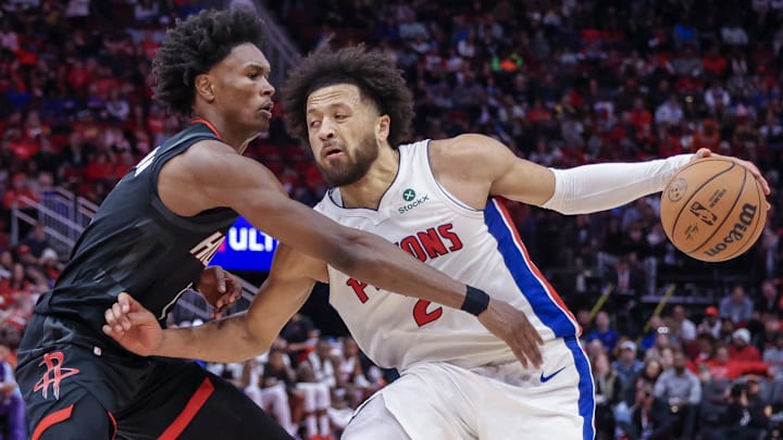 Jan 20, 2025; Houston, Texas, USA;  Detroit Pistons guard Cade Cunningham (2) dribbles against Houston Rockets forward Amen Thompson (1) in the second half at Toyota Center. Mandatory Credit: Thomas Shea-Imagn Images