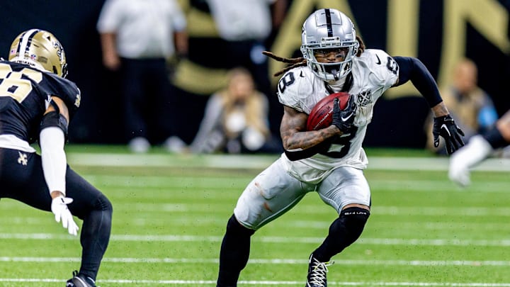 Dec 29, 2024; New Orleans, Louisiana, USA;  Las Vegas Raiders running back Ameer Abdullah (8) rushes against New Orleans Saints cornerback Travion Fluellen (26) during the second half at Caesars Superdome. Mandatory Credit: Stephen Lew-Imagn Images