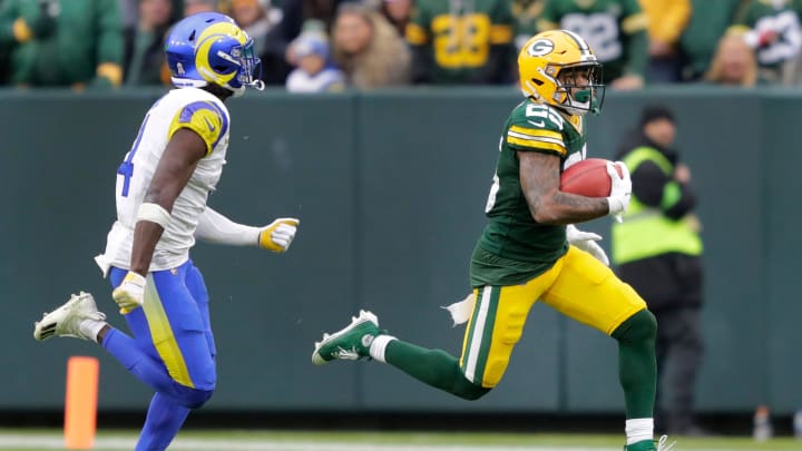 Green Bay Packers cornerback Keisean Nixon (25) runs back a kickoff return for 51-yards against Los Angeles Rams safety Jordan Fuller (4) during their  game Sunday, November 5, 2023, at Lambeau Field in Green Bay.