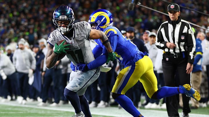Dec 18, 2025; Seattle, Washington, USA; Seattle Seahawks wide receiver Jaxon Smith-Njigba (11) runs against Los Angeles Rams cornerback Darious Williams (31) in the second half at Lumen Field. Mandatory Credit: Kevin Ng-Imagn Images