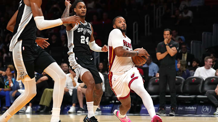 Oct 8, 2025; Miami, Florida, USA;  Miami Heat guard Norman Powell (24) drives to the basket as San Antonio Spurs guard/forward Devin Vassell (24) defends during the first half at Kaseya Center. Mandatory Credit: Jim Rassol-Imagn Images