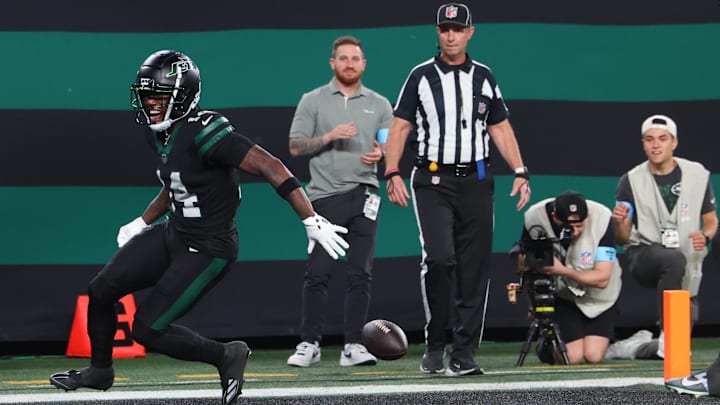 Oct 31, 2024; East Rutherford, New Jersey, USA; New York Jets wide receiver Malachi Corley (14) drops the ball prior to crossing the goal line against the Houston Texans during the first half at MetLife Stadium. 