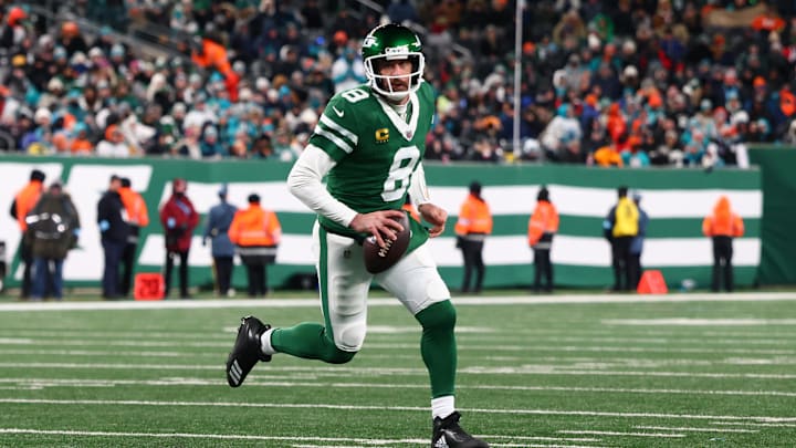 Jan 5, 2025; East Rutherford, New Jersey, USA; New York Jets quarterback Aaron Rodgers (8) runs with the ball during the third quarter of their game against the Miami Dolphins at MetLife Stadium. Mandatory Credit: Ed Mulholland-Imagn Images