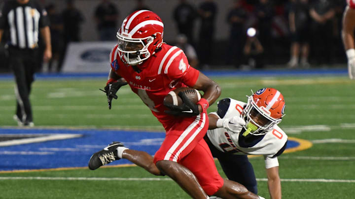 Mater Dei’s Kayden Dixon-Wyatt catches a pass and eludes a Bishop Gorman defender on Friday, September 6, 2024.