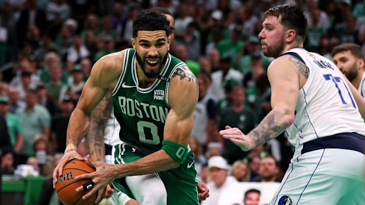 Jun 17, 2024; Boston, Massachusetts, USA; Boston Celtics forward Jayson Tatum (0) drives to the basket against Dallas Mavericks guard Luka Doncic (77) in game five of the 2024 NBA Finals at TD Garden. Mandatory Credit: Peter Casey-Imagn Images