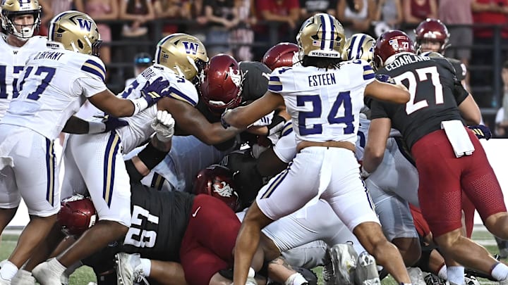 Sep 20, 2025; Pullman, Washington, USA; Washington Huskies running back Jordan Washington (4) leaps into the end zone for a touchdown against the Washington Huskies in the second half of Apple Cup at Gesa Field at Martin Stadium. Washington Huskies won 59-24. Mandatory Credit: James Snook-Imagn Images