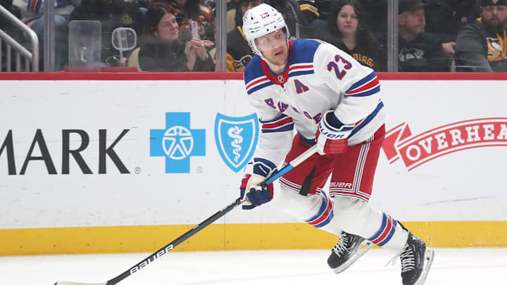 Feb 23, 2025; Pittsburgh, Pennsylvania, USA;  New York Rangers defenseman Adam Fox (23) handles the puck against the Pittsburgh Penguins during the first period at PPG Paints Arena. Mandatory Credit: Charles LeClaire-Imagn Images