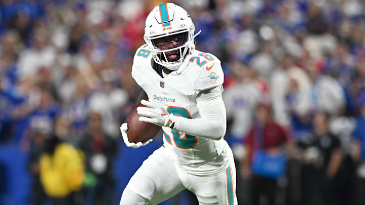 Sep 18, 2025; Orchard Park, New York, USA; Miami Dolphins running back de'von Achane (28) runs against the Buffalo Bills in the first half at Highmark Stadium. 