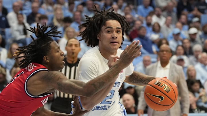Nov 6, 2023; Chapel Hill, North Carolina, USA; North Carolina Tar Heels guard Elliott Cadeau (2) dribbles as Radford Highlanders guard Truth Harris (4) defends in the second half at Dean E. Smith Center. Nov 6, 2023; Chapel Hill, North Carolina, USA; North Carolina Tar Heels guard Elliott Cadeau (2) dribbles as Radford Highlanders guard Truth Harris (4) defends in the second half at Dean E. Smith Center.