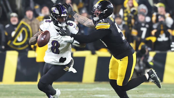 Jan 4, 2026; Pittsburgh, Pennsylvania, USA;  Baltimore Ravens quarterback Lamar Jackson (8) scrambles with the ball as Pittsburgh Steelers linebacker Nick Herbig (51) cases during the fourth quarter at Acrisure Stadium. Mandatory Credit: Charles LeClaire-Imagn Images