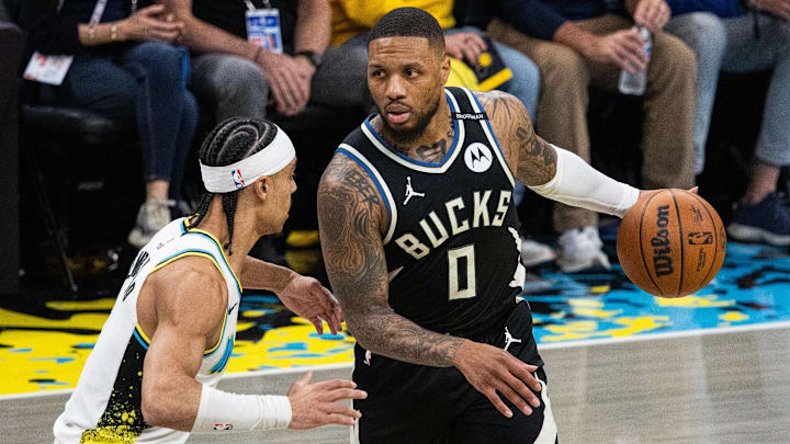 Apr 22, 2025; Indianapolis, Indiana, USA; Milwaukee Bucks guard Damian Lillard (0) dribbles  the ball while Indiana Pacers guard Andrew Nembhard (2) defends during game two of first round for the 2024 NBA Playoffs at Gainbridge Fieldhouse. Mandatory Credit: Trevor Ruszkowski-Imagn Images