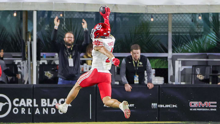 Nov 29, 2024; Orlando, Florida, USA; Utah Utes cornerback Smith Snowden (2) intercepts a UCF pass and scores a touchdown during the second half at FBC Mortgage Stadium. Mandatory Credit: Mike Watters-Imagn Images