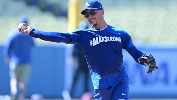 Aug 5, 2024; Los Angeles, California, USA;  Los Angeles Dodgers second baseman Mookie Betts (50) fields ground balls prior to the game against the Philadelphia Phillies at Dodger Stadium. Dodger players wore #MaxStrong shirts during pregame to honor Max, the 3-year old son of first baseman Freddie Freeman (5), who was diagnosed with Guillian-Barre syndrome. Mandatory Credit: Jayne Kamin-Oncea-USA TODAY Sports
