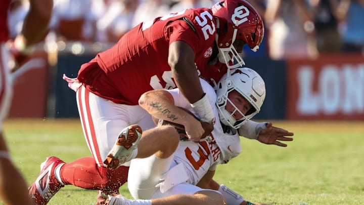 Oklahoma defensive tackle Damonic Williams tackles Quinn Ewers.