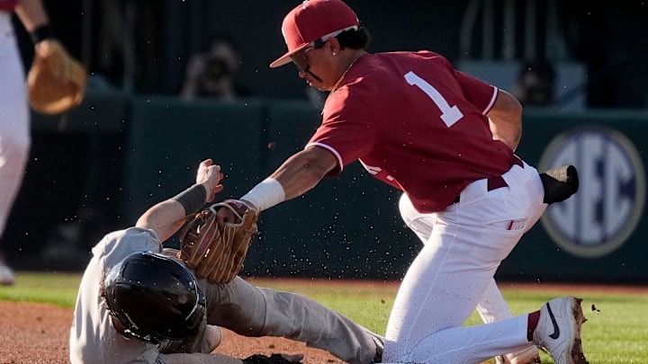 Feb 25, 2025; Tuscaloosa, AL, USA; Alabama shortstop Justin Lebron takes a throw from catcher Brady Neal to catch Jacksonville State’s Caleb Johnson as he attempts to steal second at Sewell-Thomas Stadium.