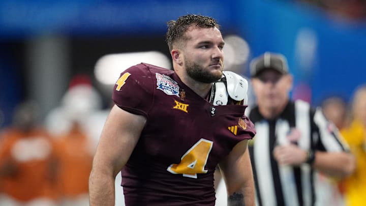 Arizona State Sun Devils running back Cam Skattebo (4) reacts after losing his helmet while being tackled by Texas Longhorns defensive back Michael Taaffe (16) during the second half of the Peach Bowl at Mercedes-Benz Stadium.